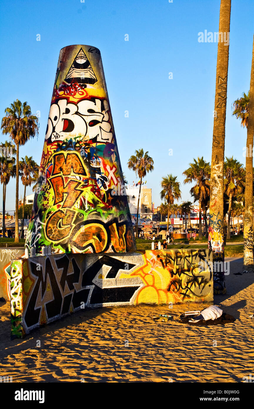Concrete graffiti wall and tower on Venice beach with the sunset