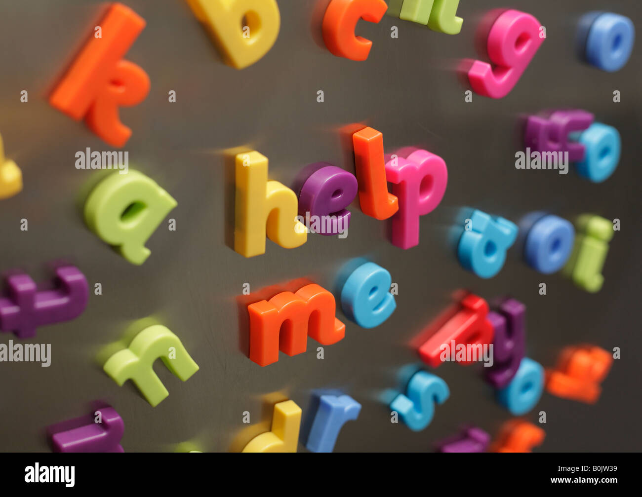 Toy magnetic letters spelling out "help me". Stock Photo