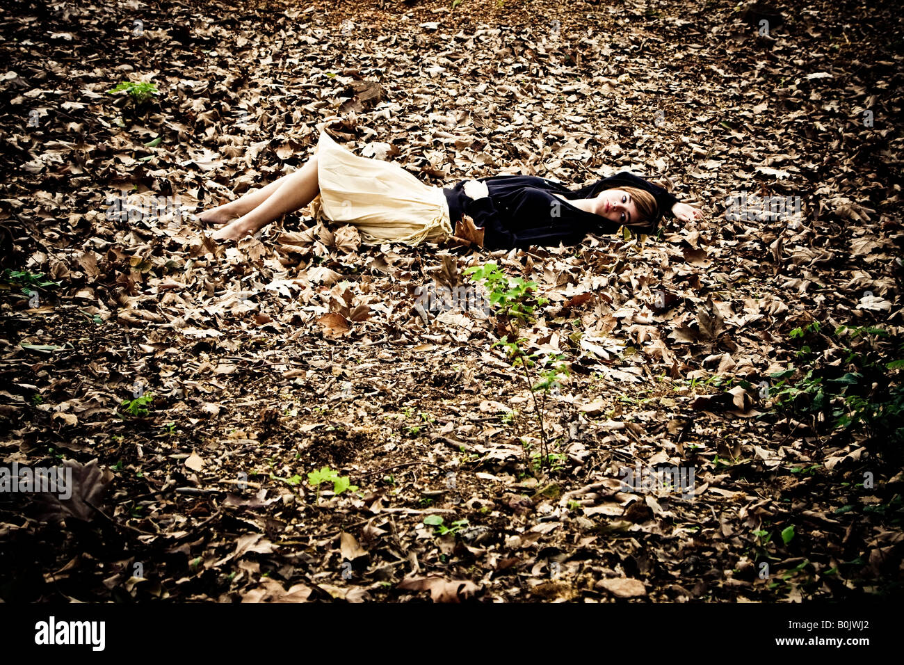 Woman laying on leaves autumn background Stock Photo - Alamy