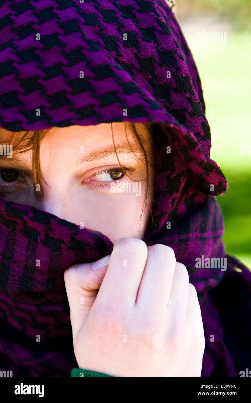 Staring woman portrait covered by violet veil Stock Photo