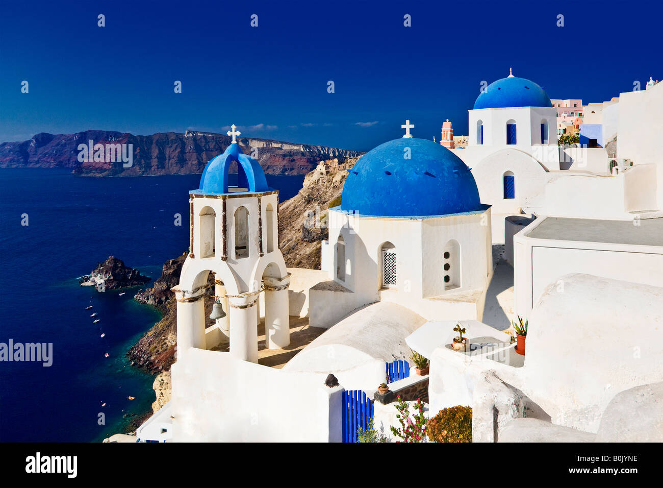 Blue dome rooftops of churches looking over the ocean Oia, Santorini, Greece Stock Photo