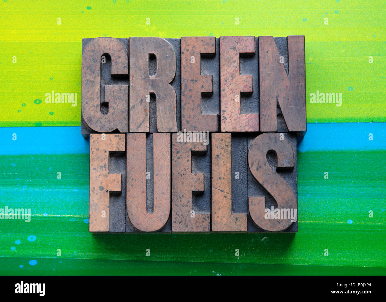 the phrase 'green fuels' in letterpress wood type on a green and blue background Stock Photo