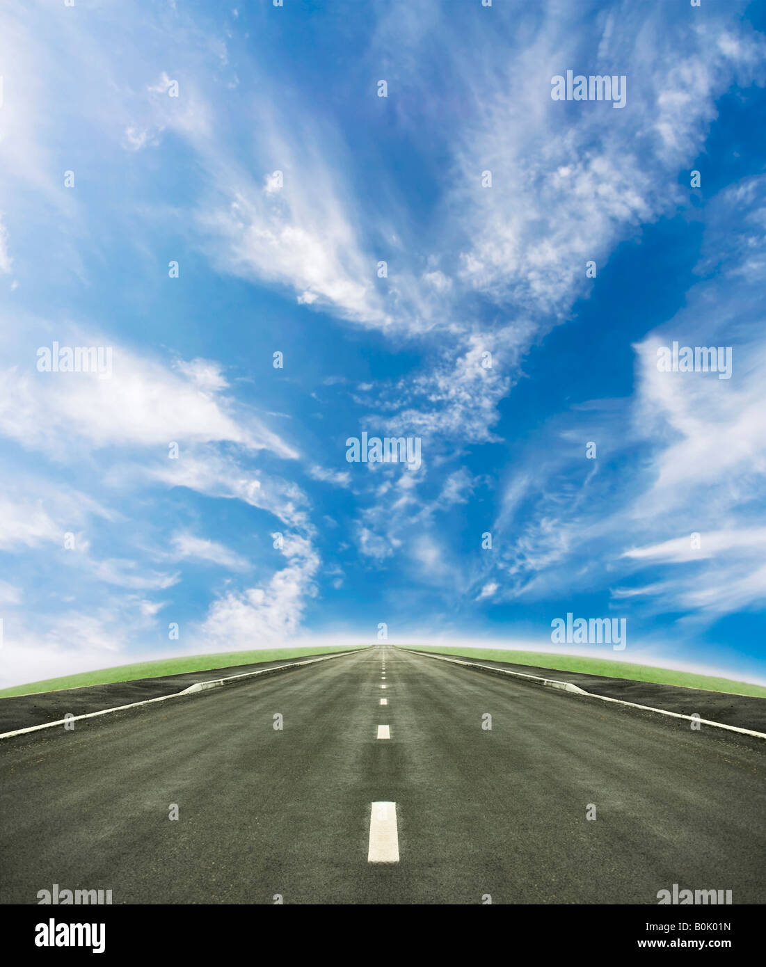 Shot of a tarmac road leading into the horizon Beautiful blue sky and ...