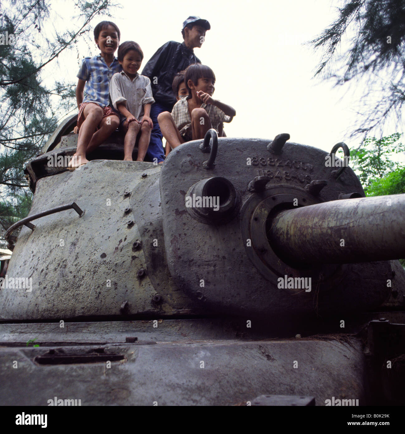 Children on top of American M48tank wreck. Near Danang, Vietnam. Stock Photo