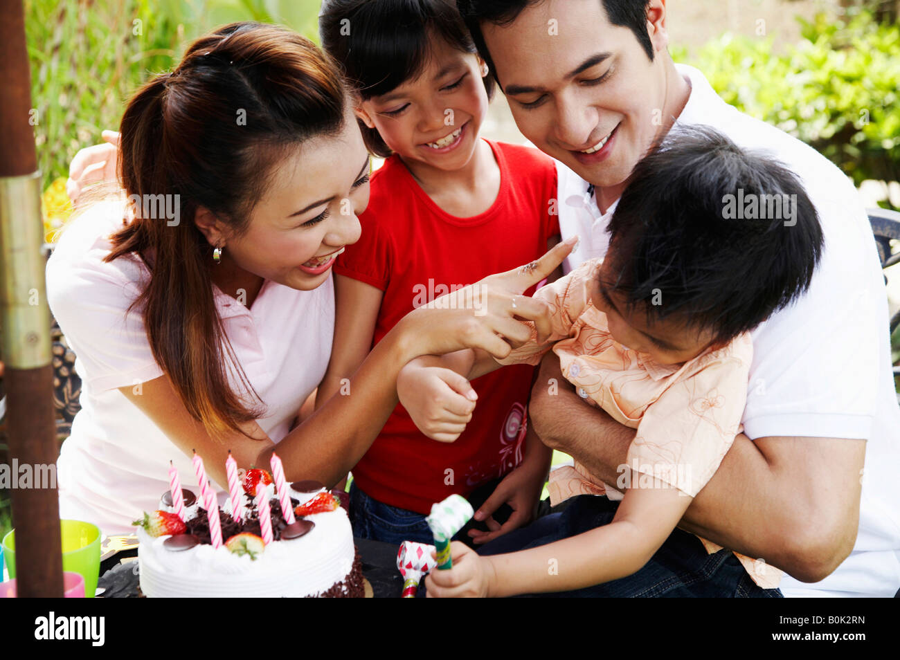 Son And Family Celebrate Birthday In The Garden Stock Photo Alamy son-and-family-celebrate-birthday-in-the-garden-stock-photo-alamy