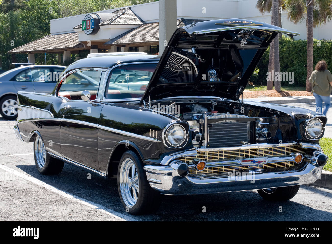 1957 Chevrolet coupe automobile with hood lifted to expose the engine at an auto show in Ponte Vedra Beach, Florida Stock Photo