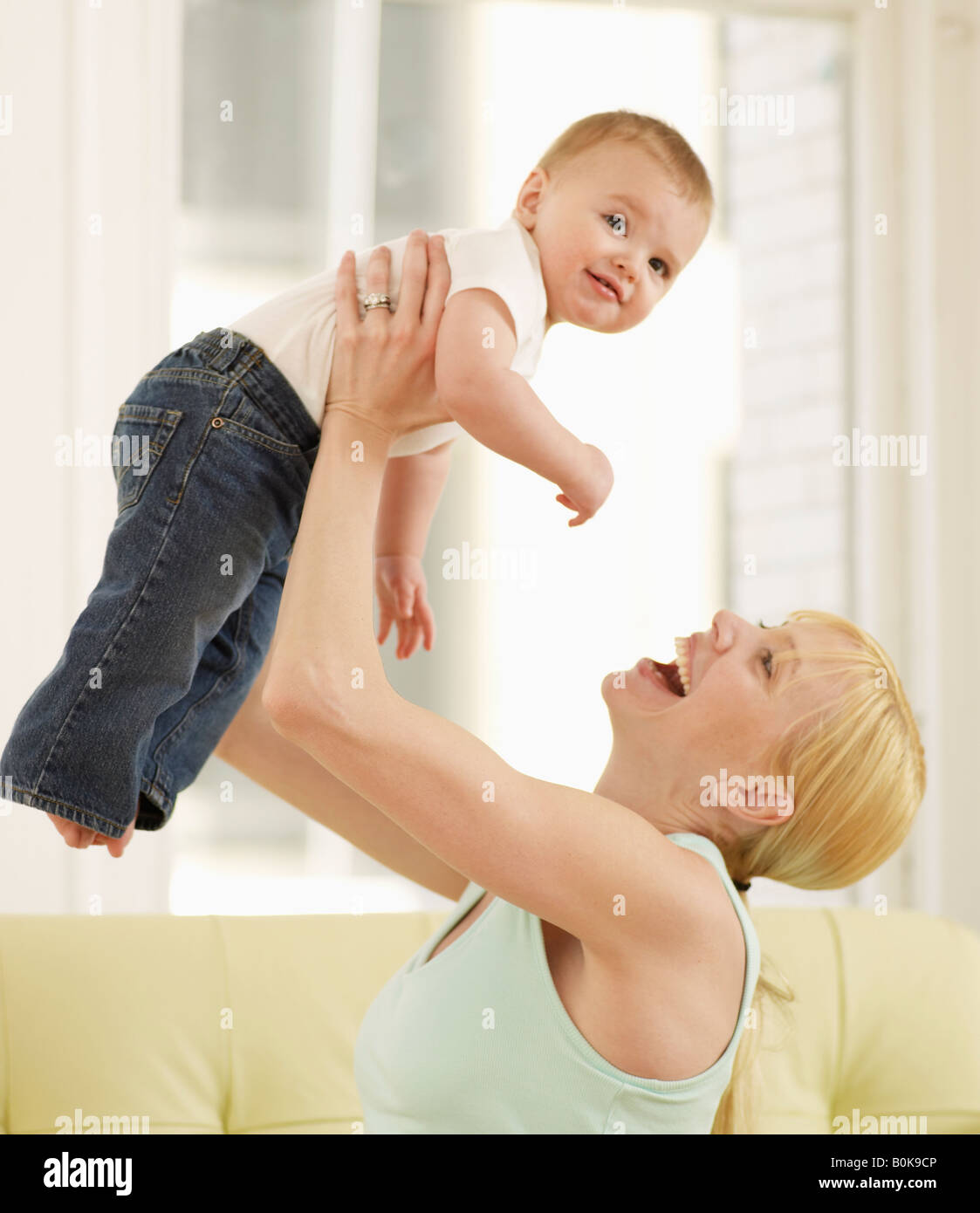 Mother Lifting Baby Boy Stock Photo Alamy
