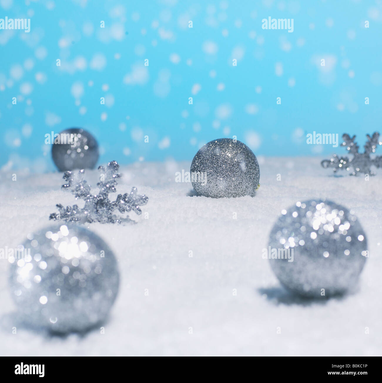 Silver christmas baubles in the snow hi-res stock photography and ...
