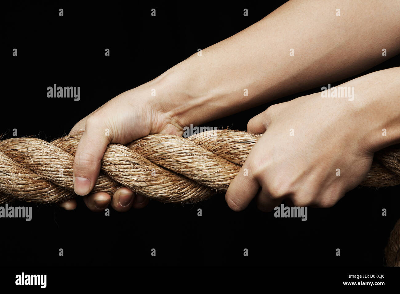 Person Pulling Rope Stock Photo