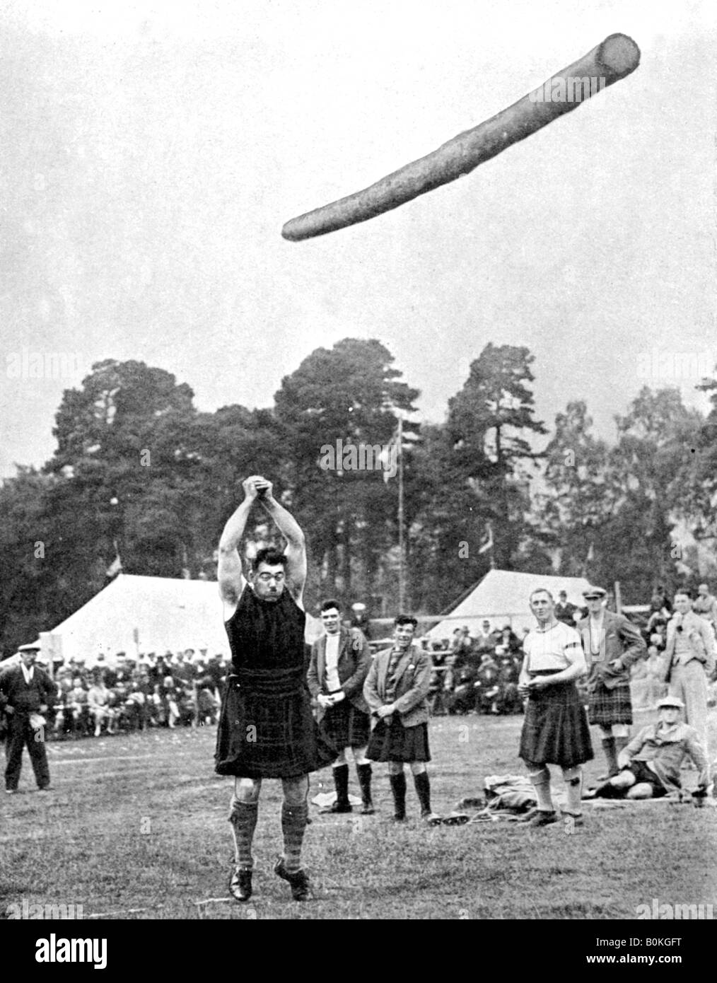 Tossing the caber at the Highland games, Scotland, 1936. Artist: Fox Stock Photo