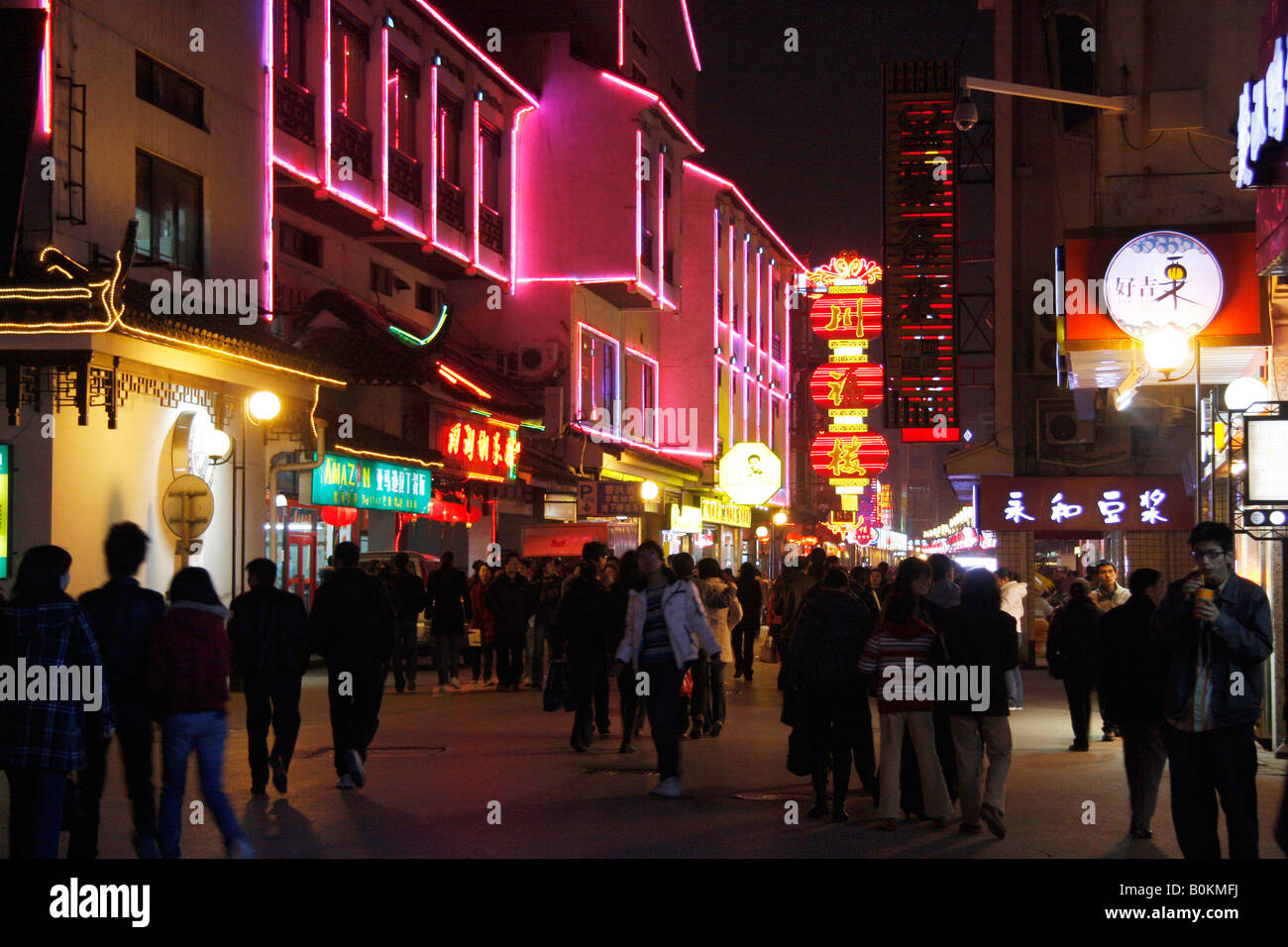 Busy nightlife in the main shopping street in Suzhou with many  shop signs,people and illuminations Stock Photo