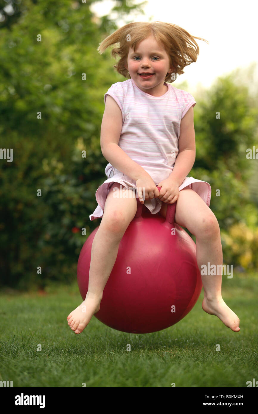 Child bouncing on spacehopper toy Stock Photo Alamy