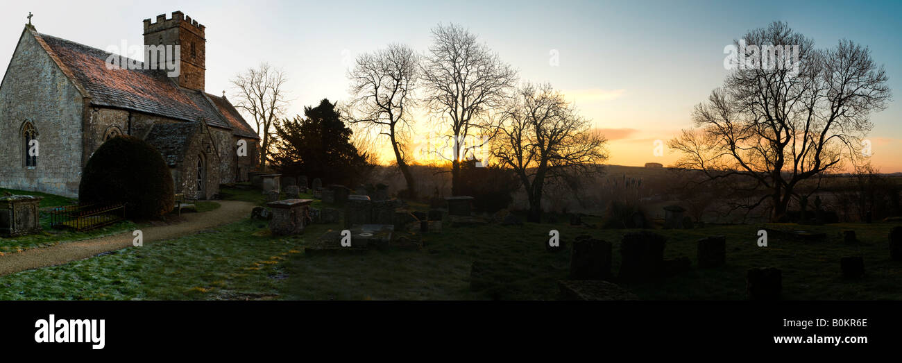 A winter dawn in a Cotswold churchyard at Brimpsfield, Gloucestershire Stock Photo