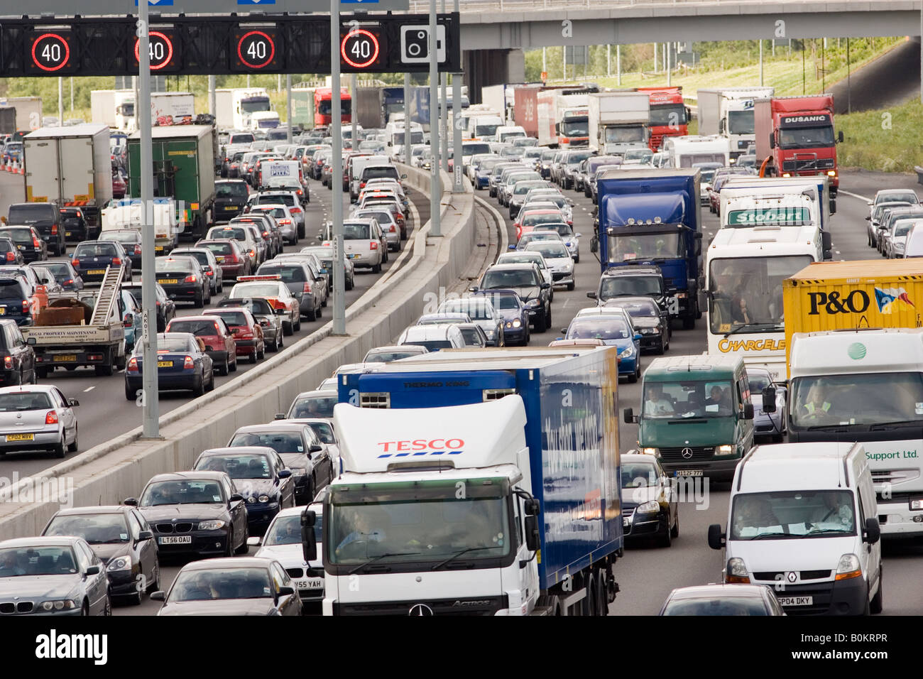 Traffic congestion of cars and trucks at a standstill in both