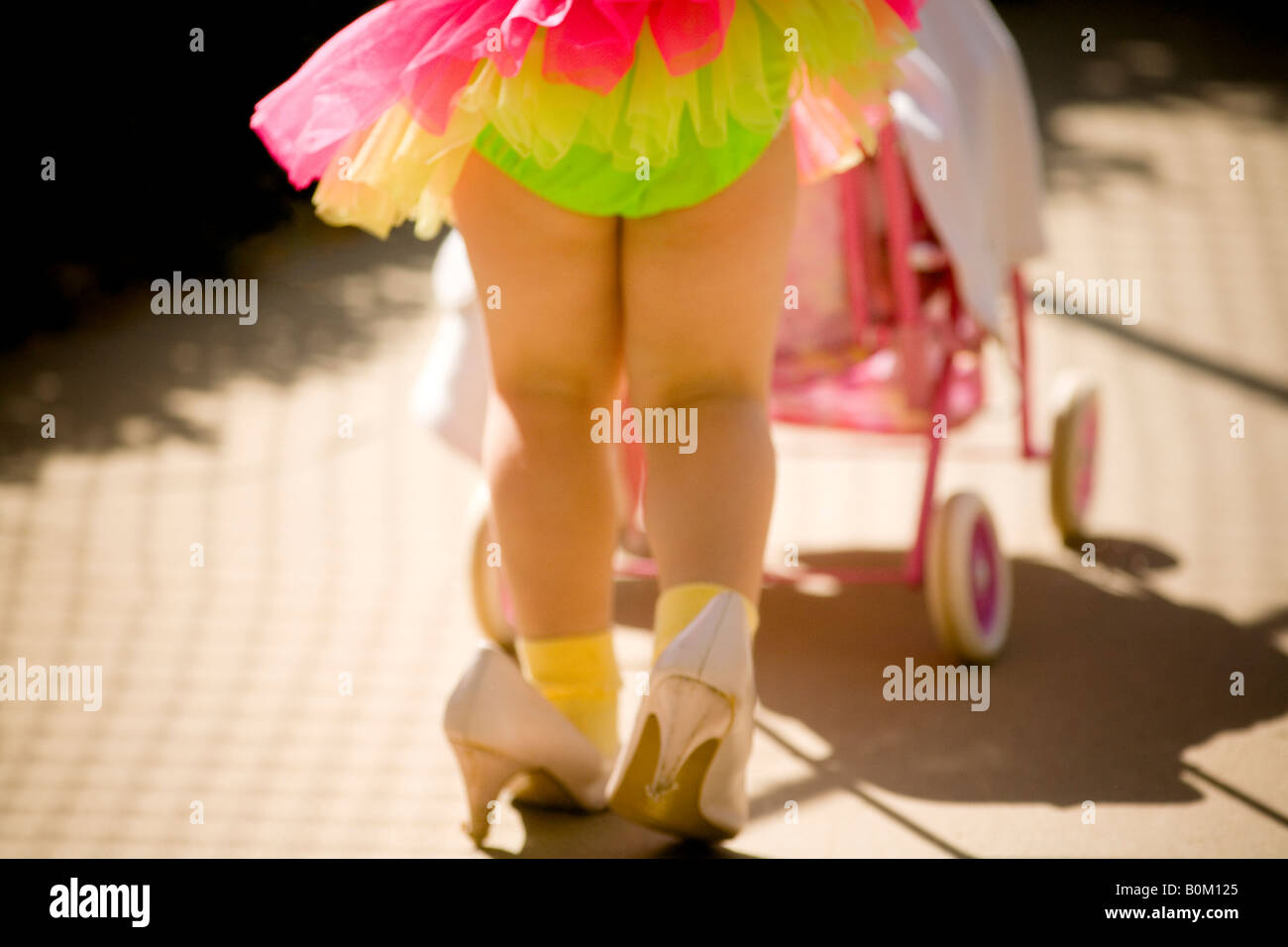 girl, play, dress-up, mother-roll, imagine, young, shoe, little foot in big shoe, moms shoes, baby stroller, toy, imagination, Stock Photo