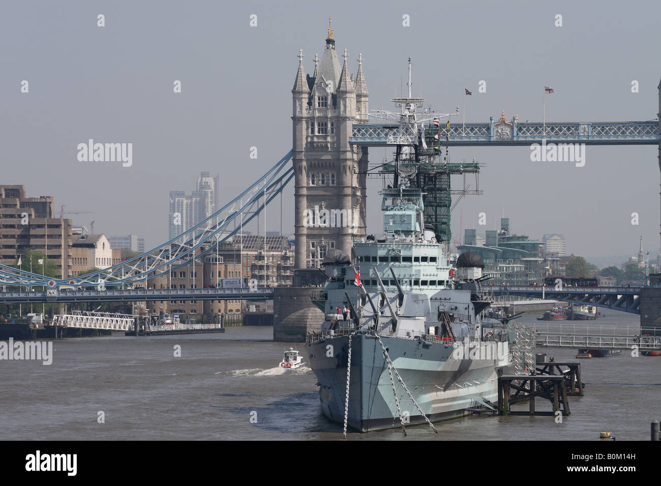 London England HMS Belfast the former World War 2 cruiser is moored alongside Tower Bridge and is a floating museum Stock Photo