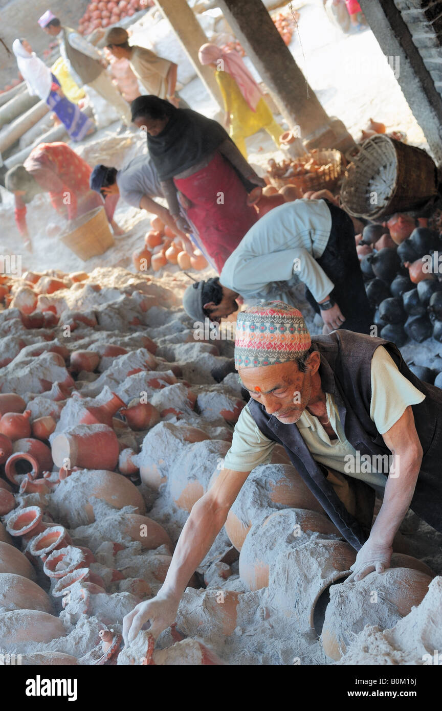 Communal pottery kiln being emptied in Bhatapur Nepal Kathmandu Valley. Traditional craft workers in a cooperative scheme. Stock Photo
