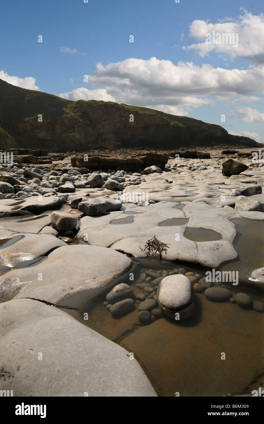 Rocks sea water  pools blue sky Dunraven Bay South Wales Stock Photo