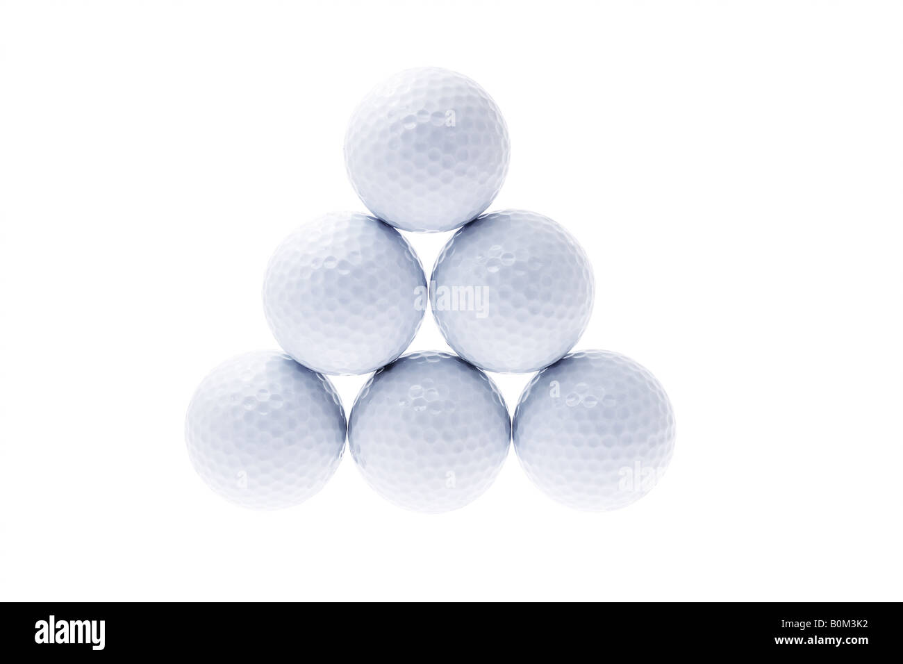 Golf balls stacked up in triangular shape Stock Photo