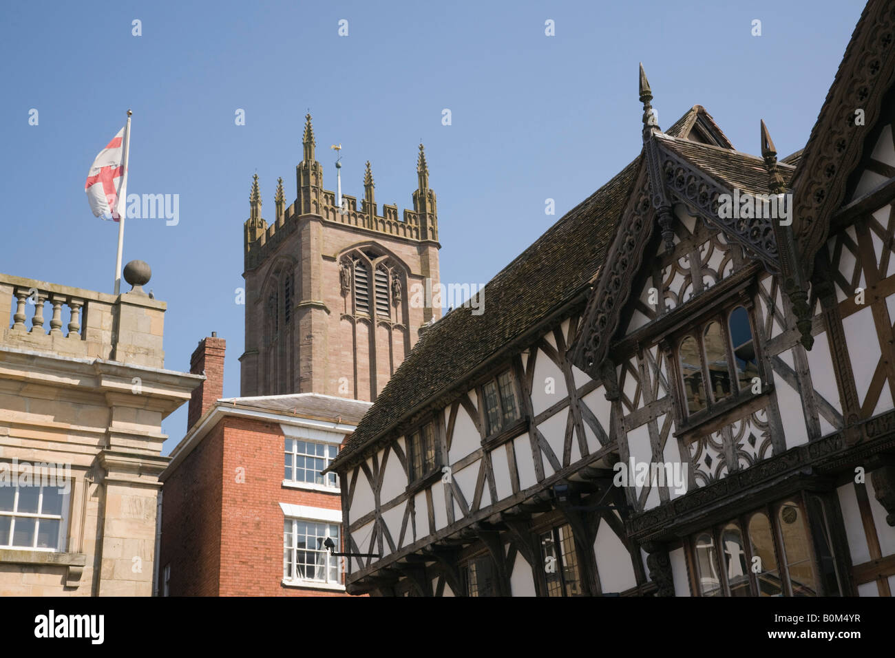 Ludlow Shropshire West Midlands England UK Black and white timber framed medieval building with church of St Laurence tower Stock Photo