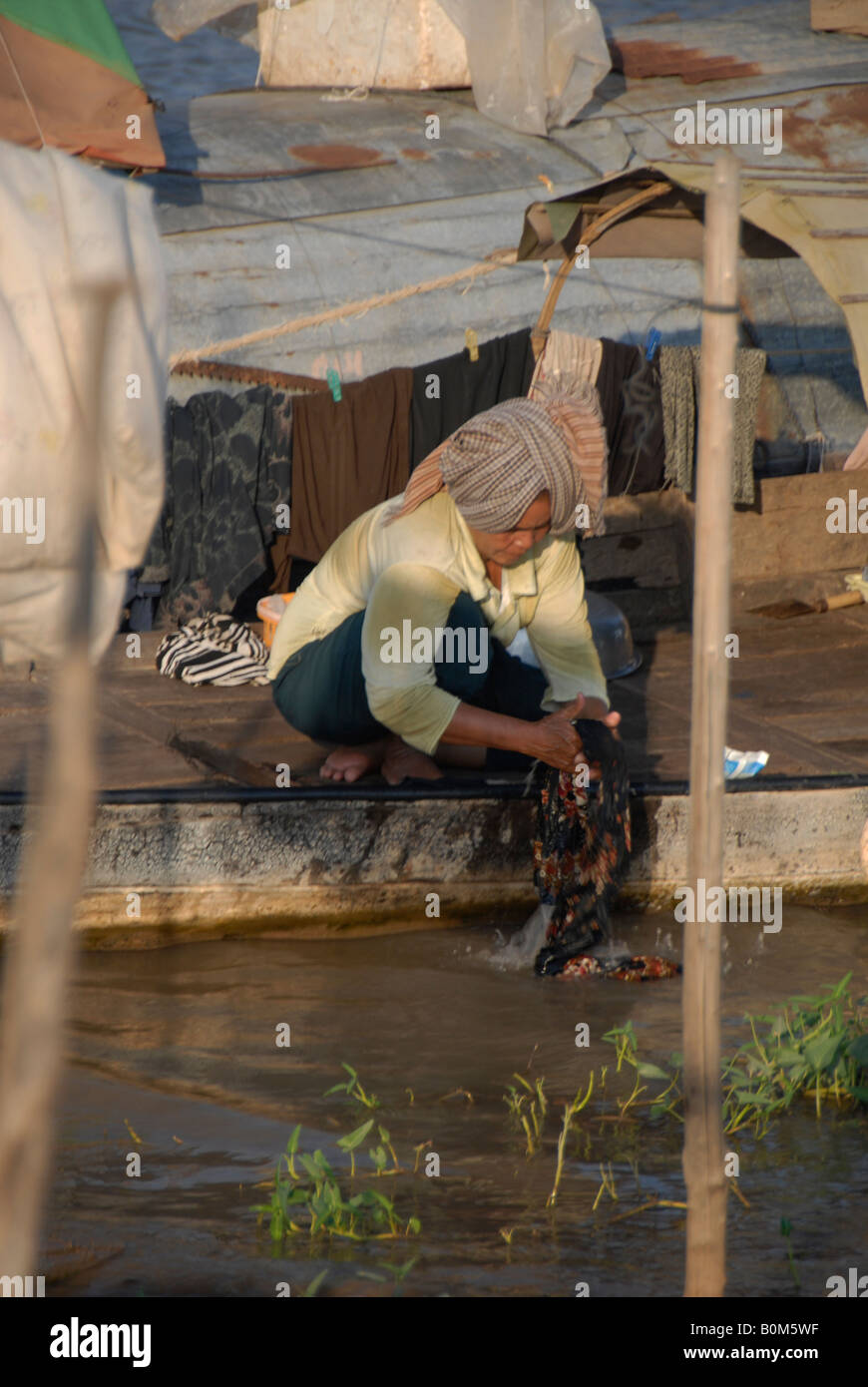 Lady Doing The Laundry Muslim Village Mekong River Phnom Penh