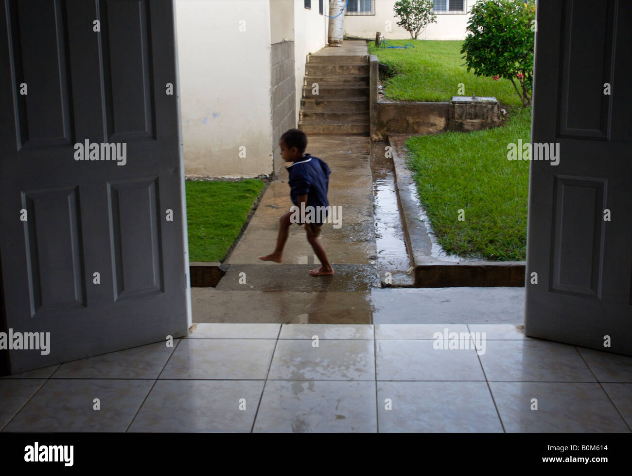 A child plays in the rain during a 2006 surgical mission to Sula Santa Barbara hospital in Honduras November 1 2006 Photo by Joe Stock Photo