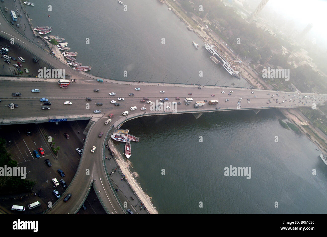 Traffic crossing the River Nile to Gezira Island by a road bridge in central Cairo Egypt Stock Photo