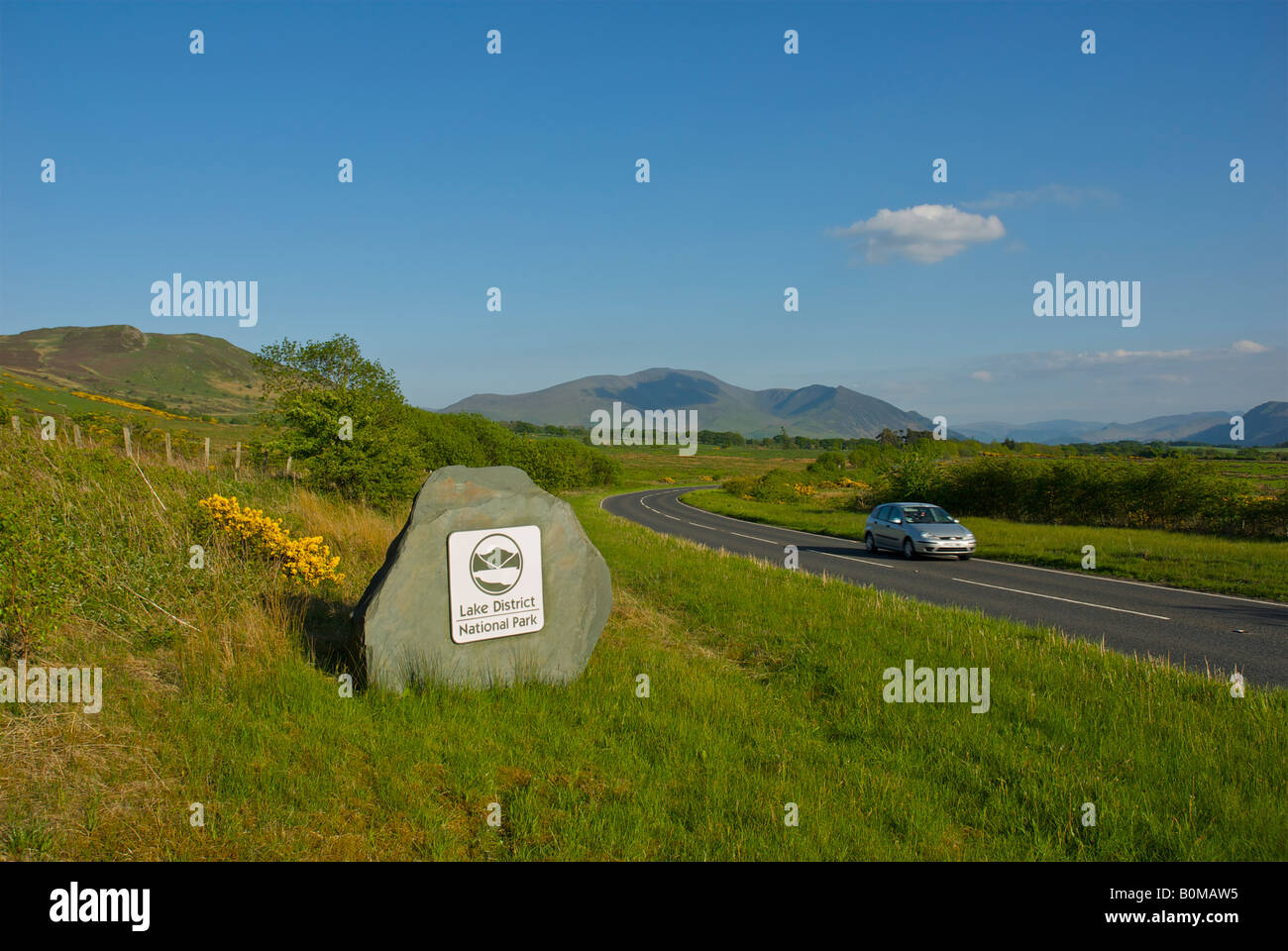 Lake District National Park sign on A591 road, with Skiddaw in the background, Lake District National Park, Cumbria, England UK Stock Photo