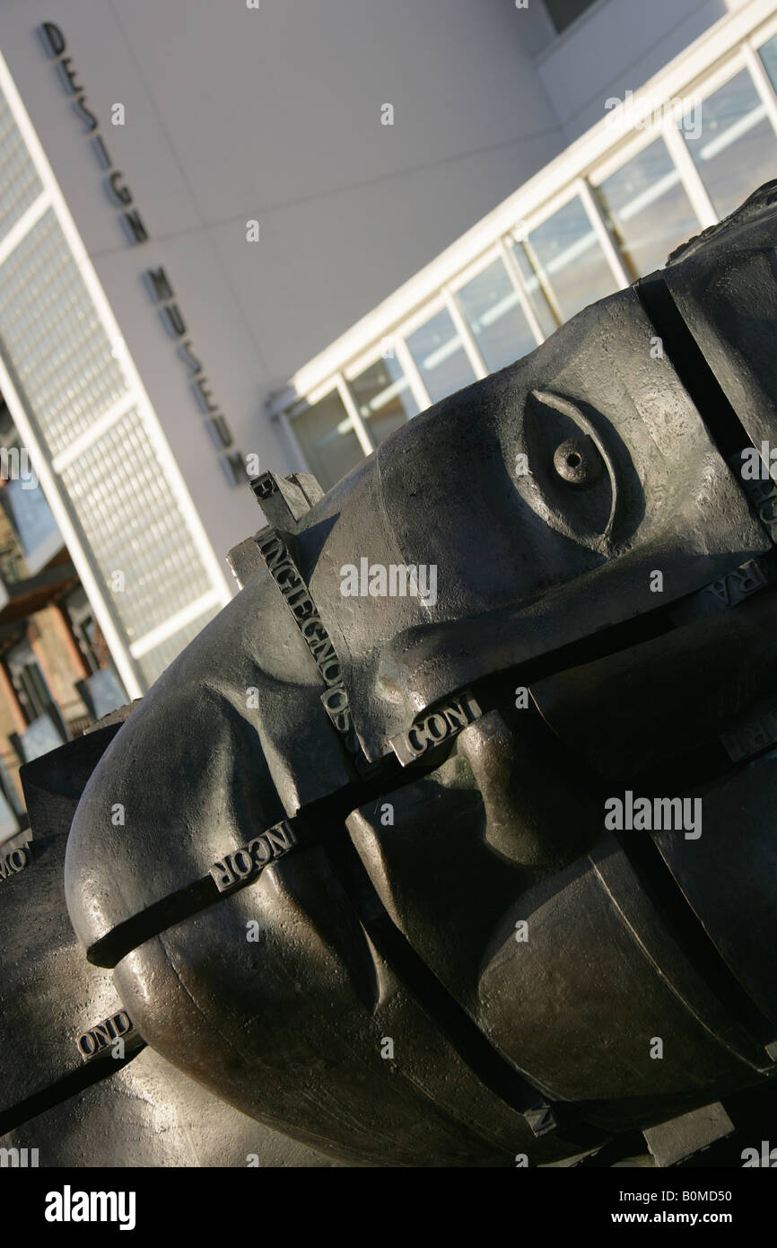Angled view of the Invention sculpture by Sir Eduardo Luigi Paolozzi with the Design Museum at Butlers Wharf in the background. Stock Photo