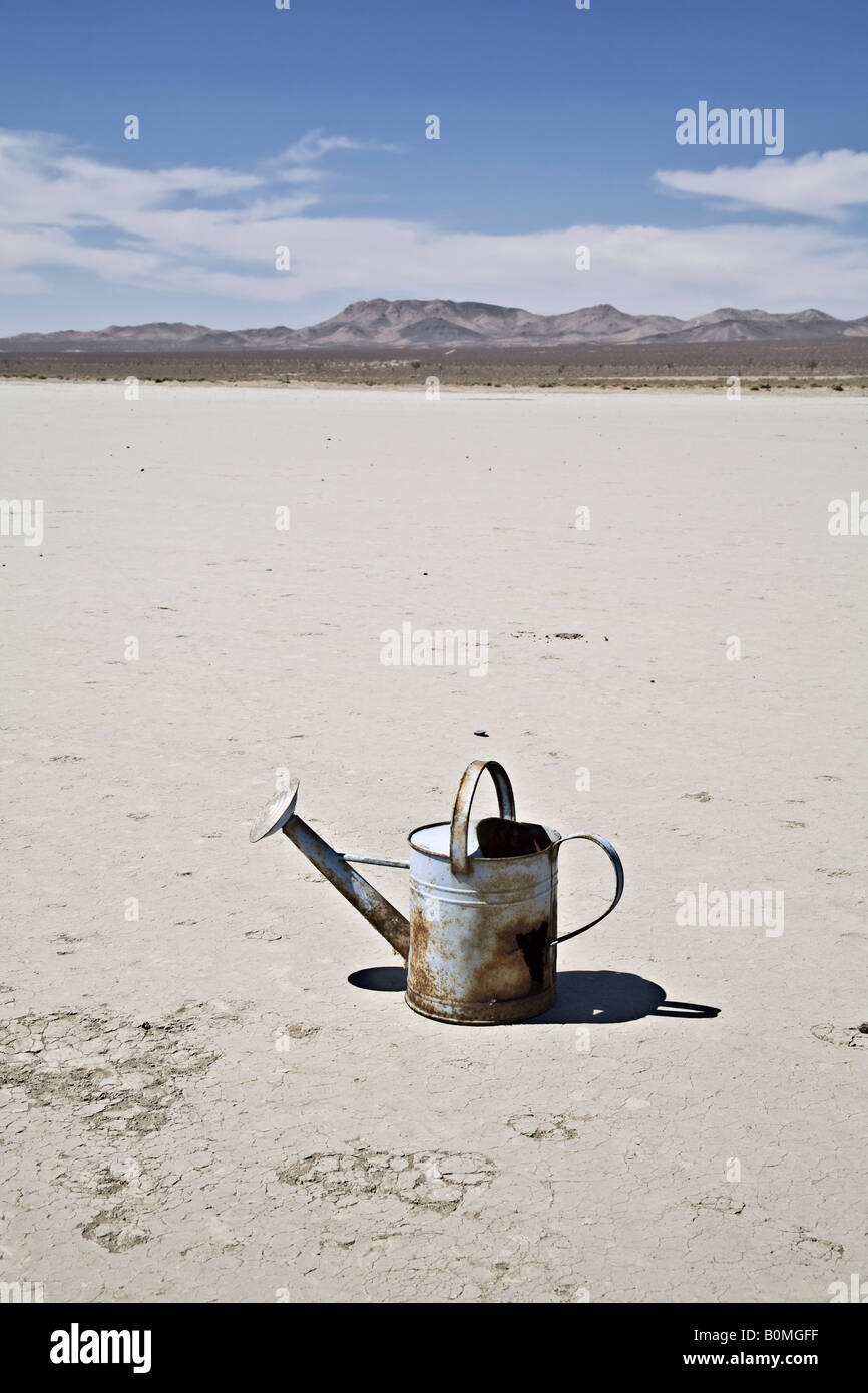 Rusty watering can in the desert Stock Photo
