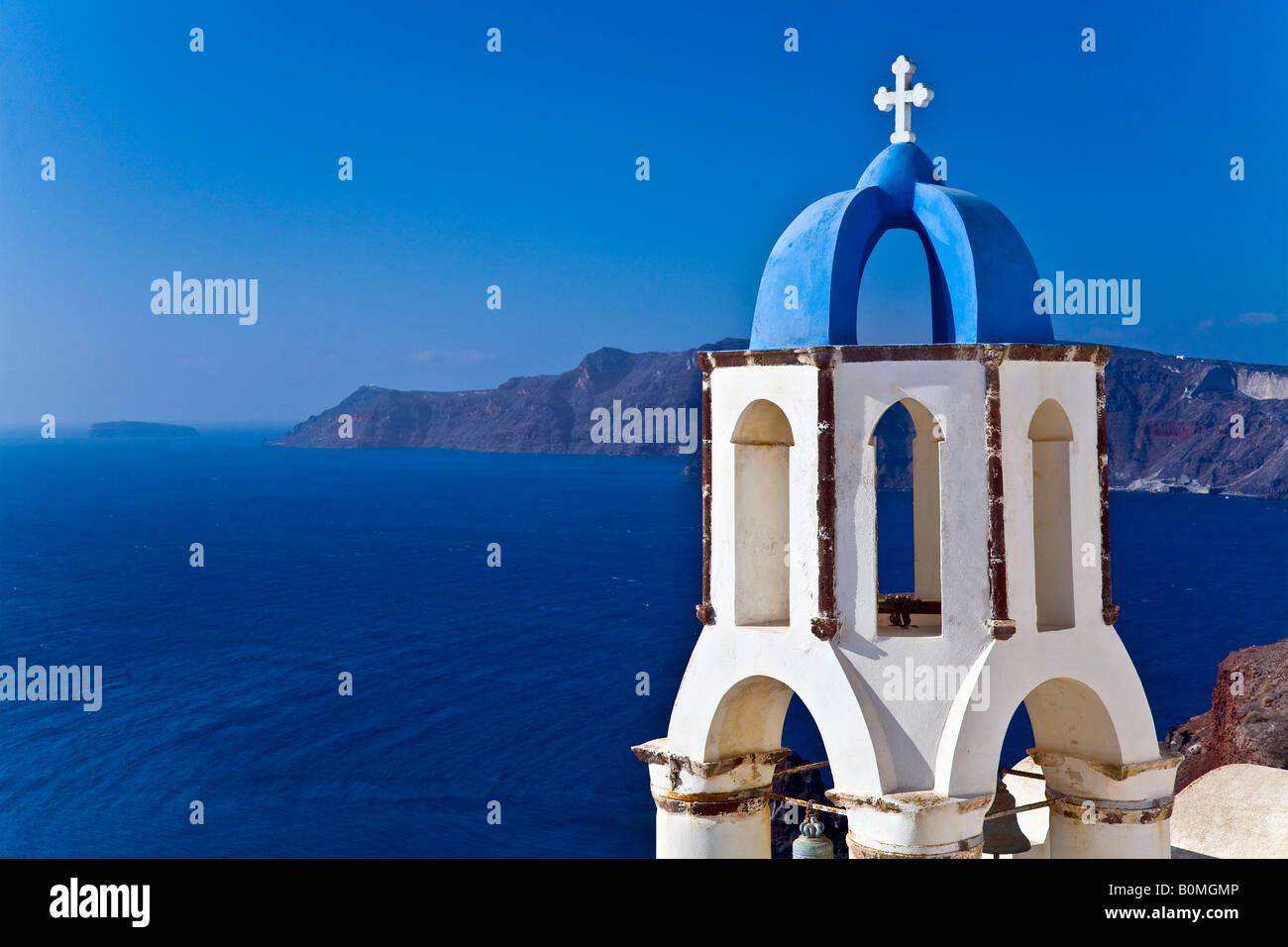 Blue and white church tower with ocean view Oia, Santorini, Greece Stock Photo