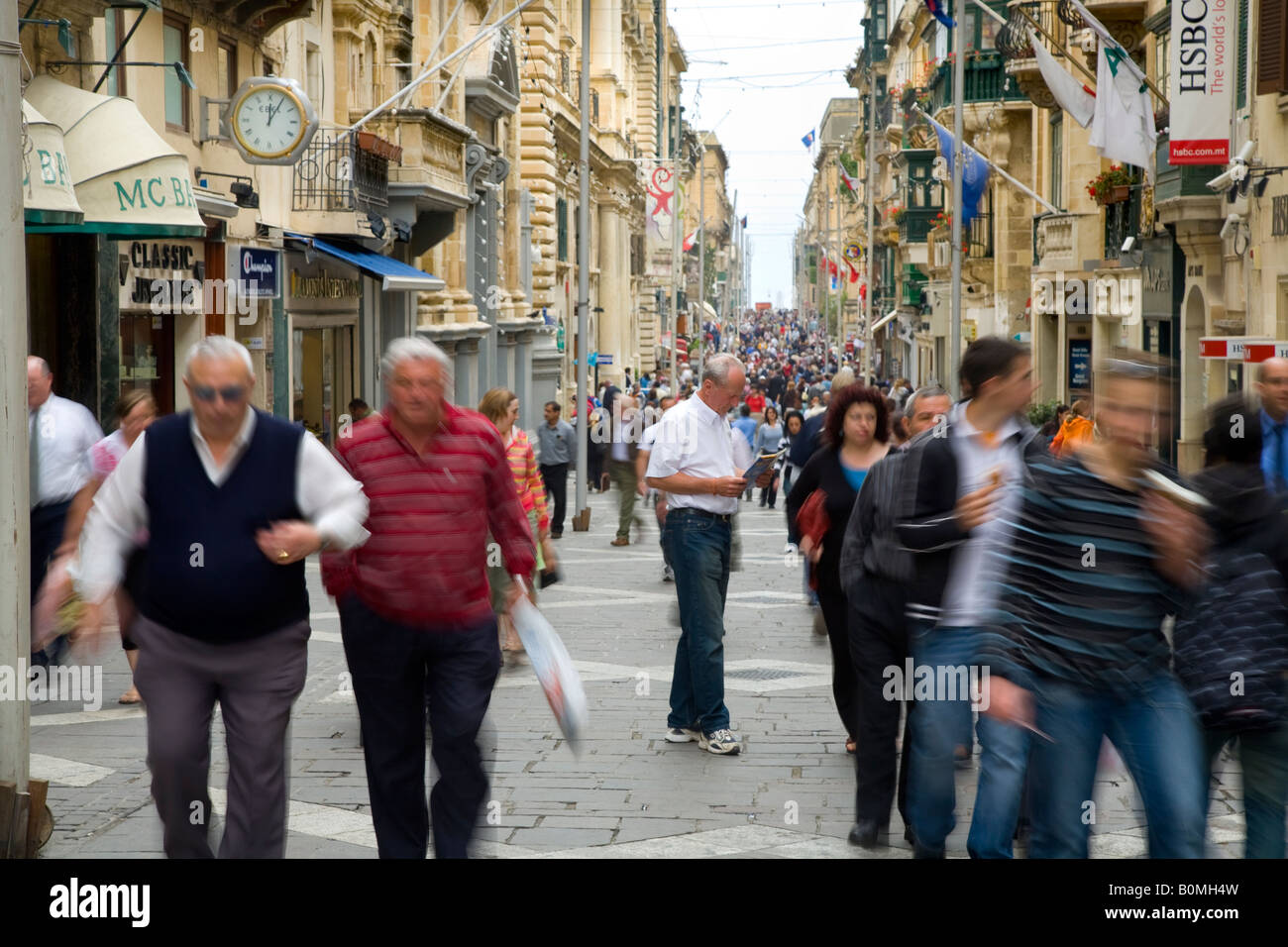 Main shopping street with crowds of shoppers & tourists at  the Main Shopping street & thoroughfare on the holiday Island of Valletta, Malta. Stock Photo
