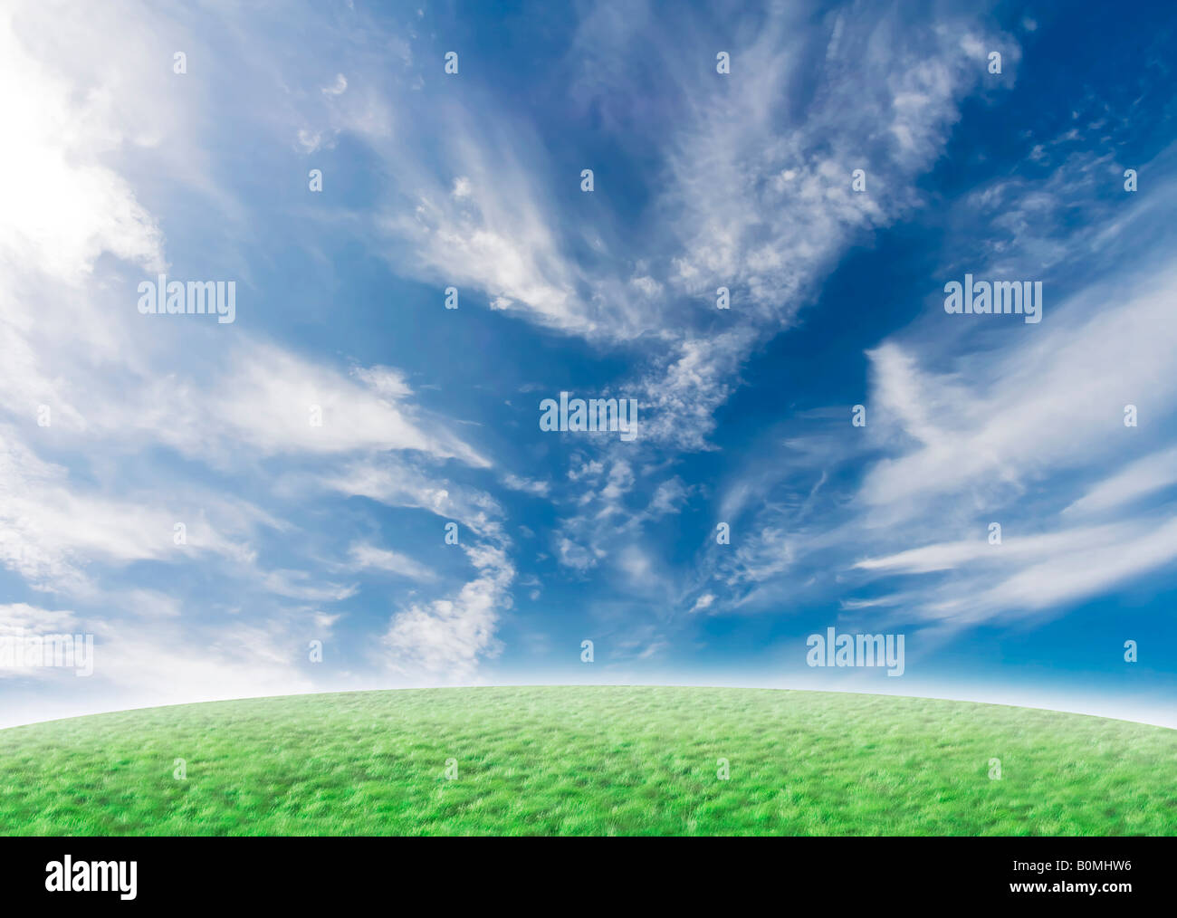 Beautiful nature background with green grass and blue vivid sky with clouds Stock Photo
