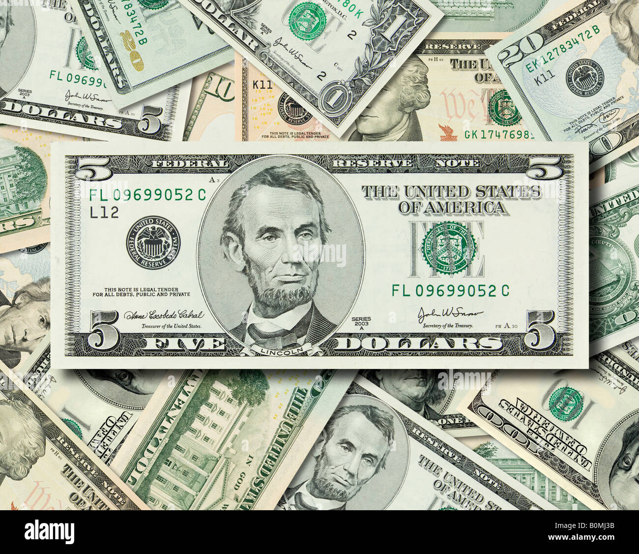 Composite shot of different American Dollar bills piled together with Lincoln s 5 dollar bill in front Stock Photo