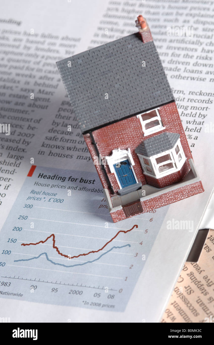 a model of a house on a copy of the financial times Stock Photo