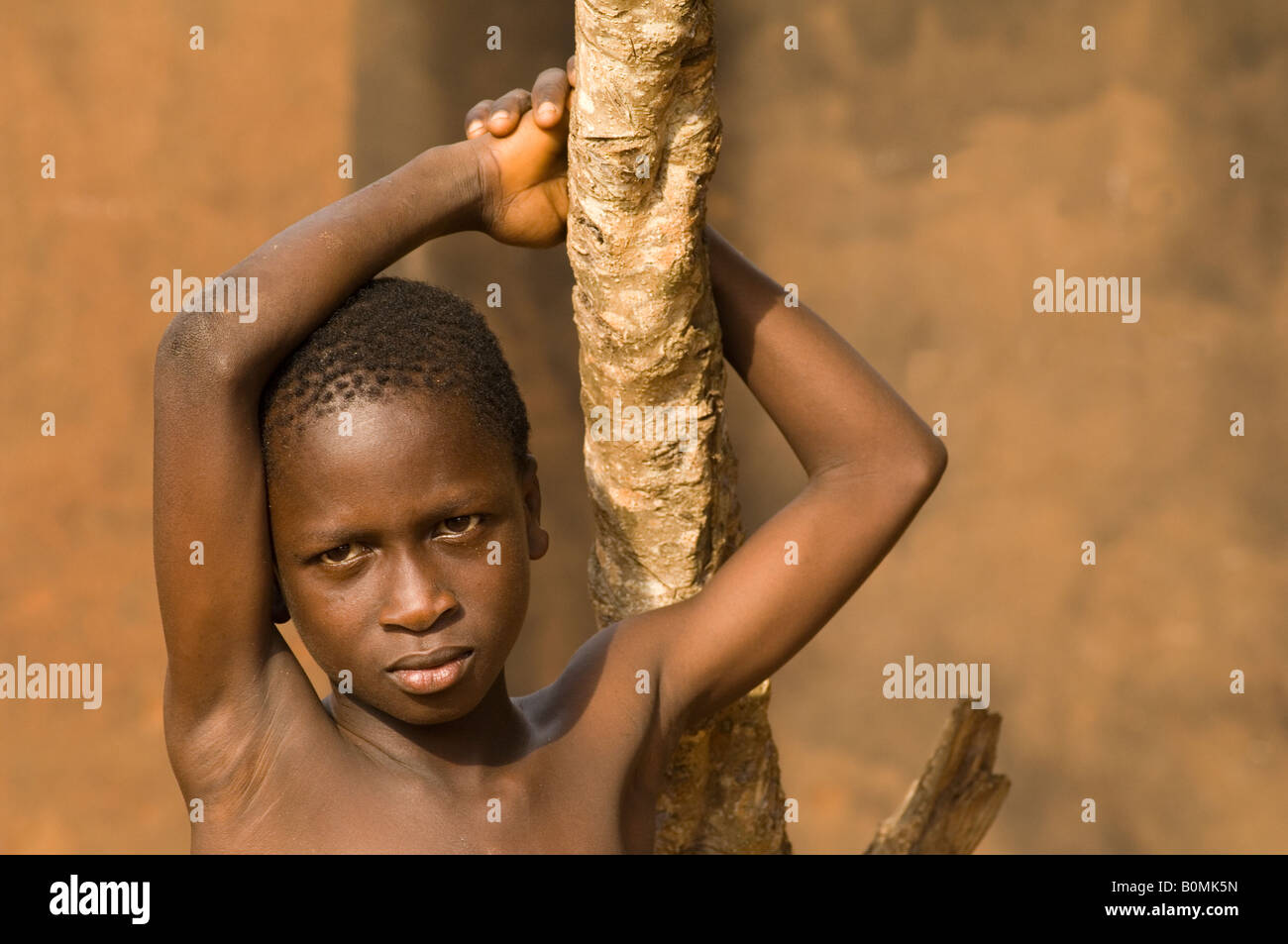A curious boy relaxes in a pose, Kuluedor, Ghana Stock Photo