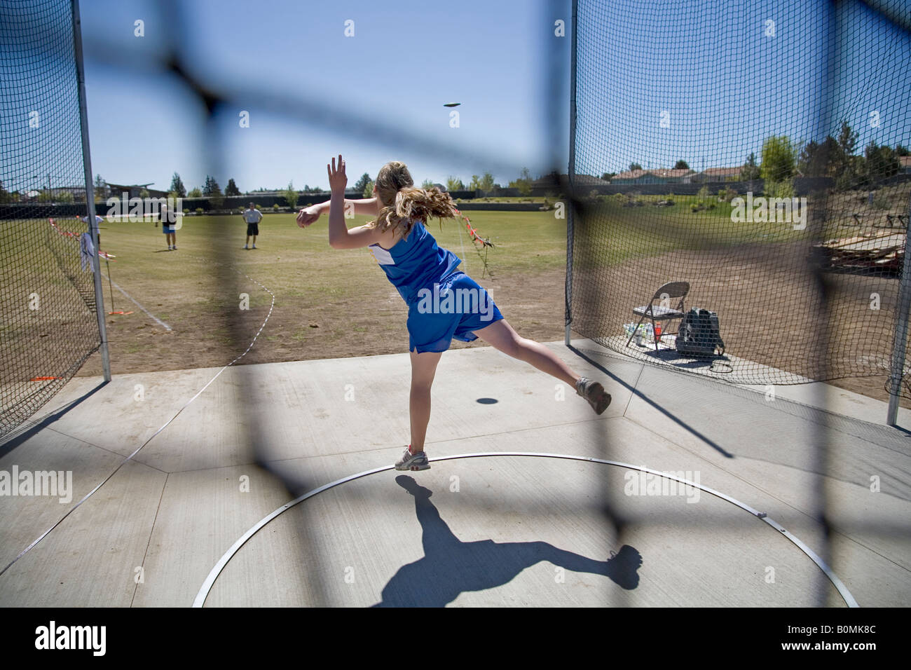 A middle school junior high school district track meet in the spring track season This is a girl s discus throw Stock Photo