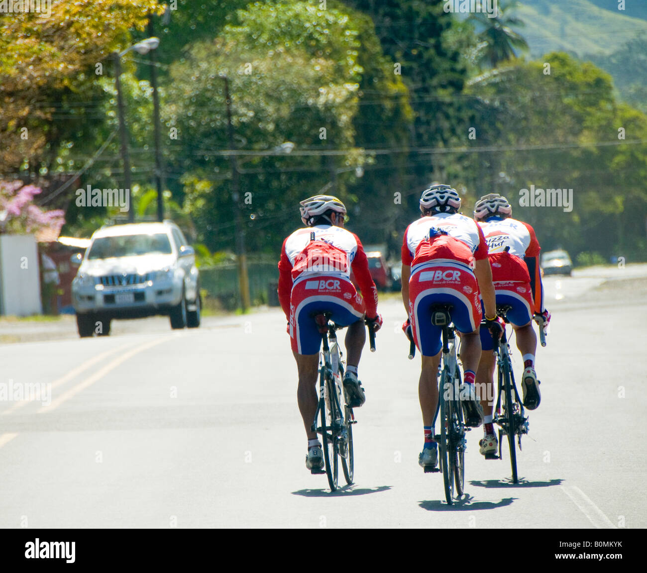 COSTA RICA Cyclists riding through the streets of Turrialba Cartago Province Caribbean Slope Stock Photo
