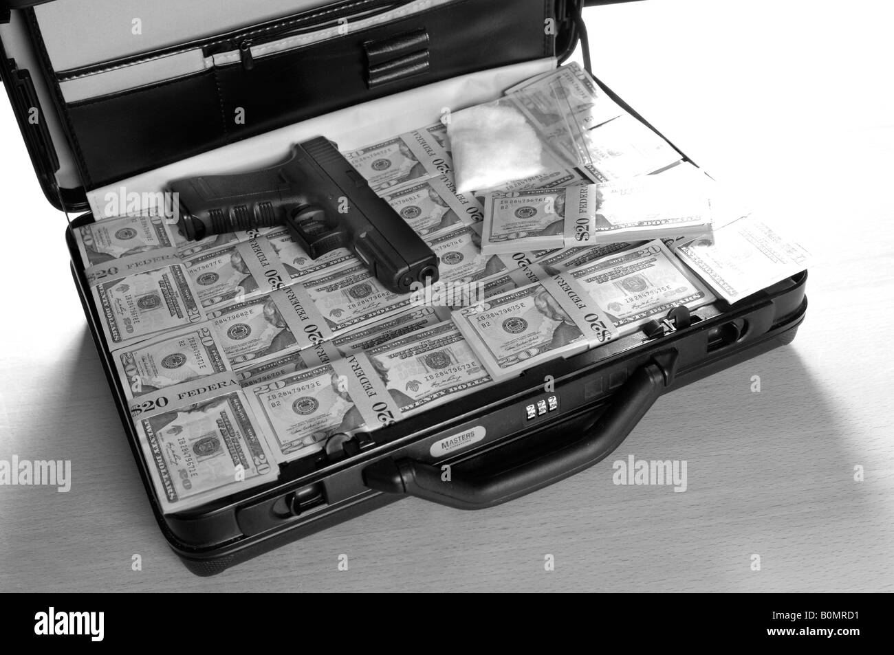a briefcase full of money with a gun and some drugs in it (replica gun) Stock Photo