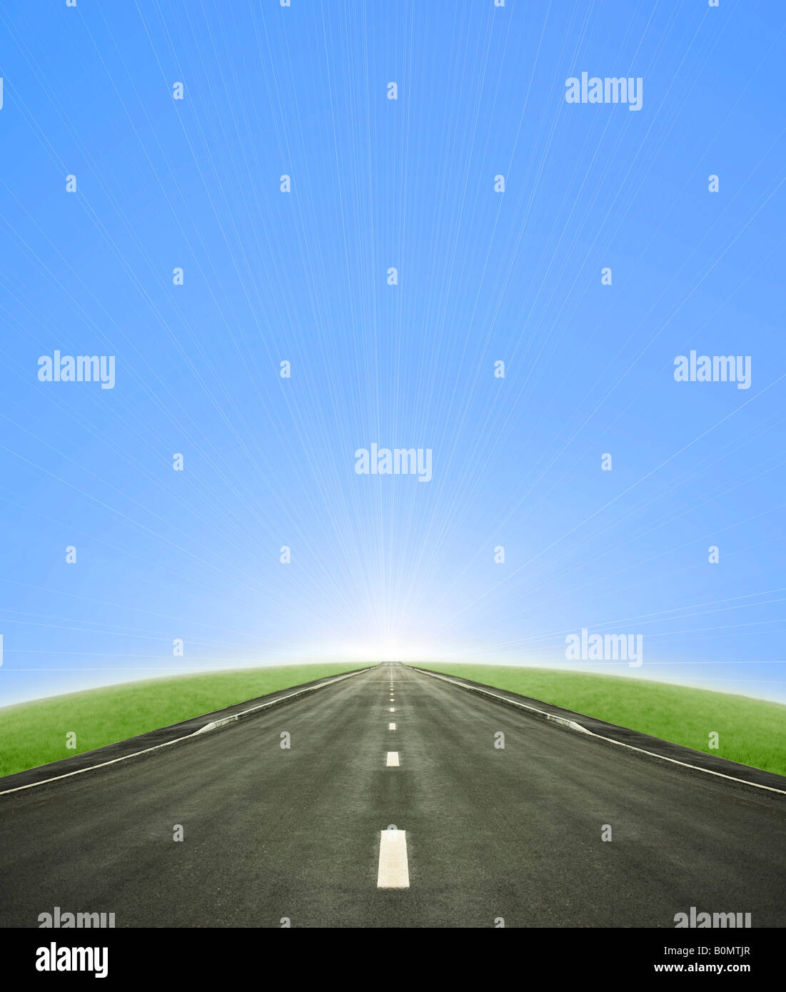 Shot of a tarmac road leading into the horizon and the sun with a blue ...