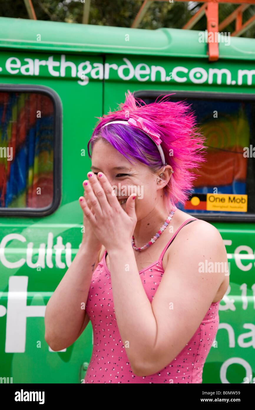 Woman Eco-Warriors Earth garden; Girl in pink outfit with matching dyed purple hair,  green vehicle Malta Stock Photo