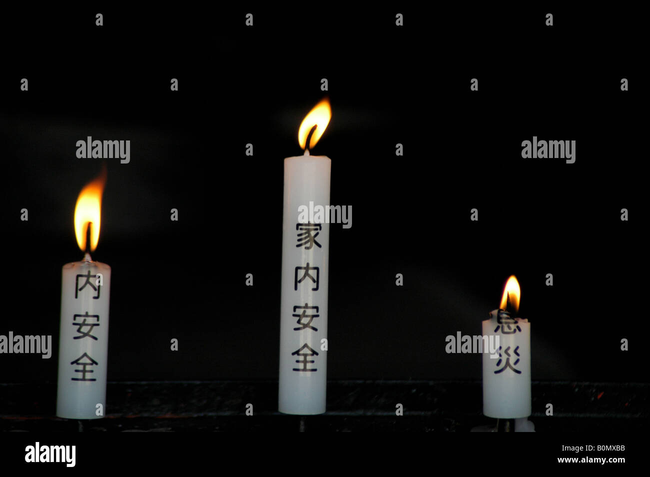 three candles with shingon prayers written on Stock Photo