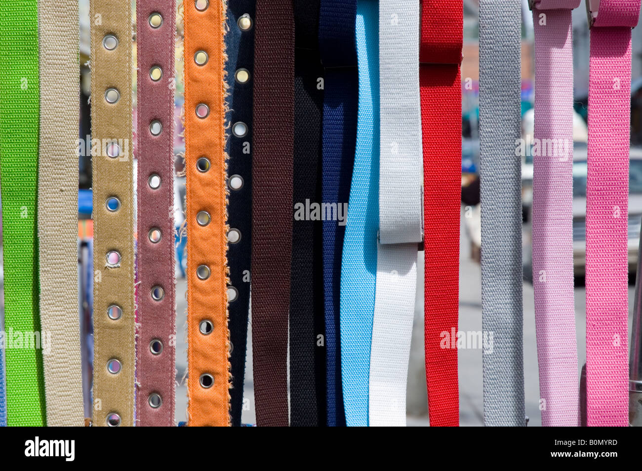 Colourful belts on display at outdoor shop Stock Photo - Alamy