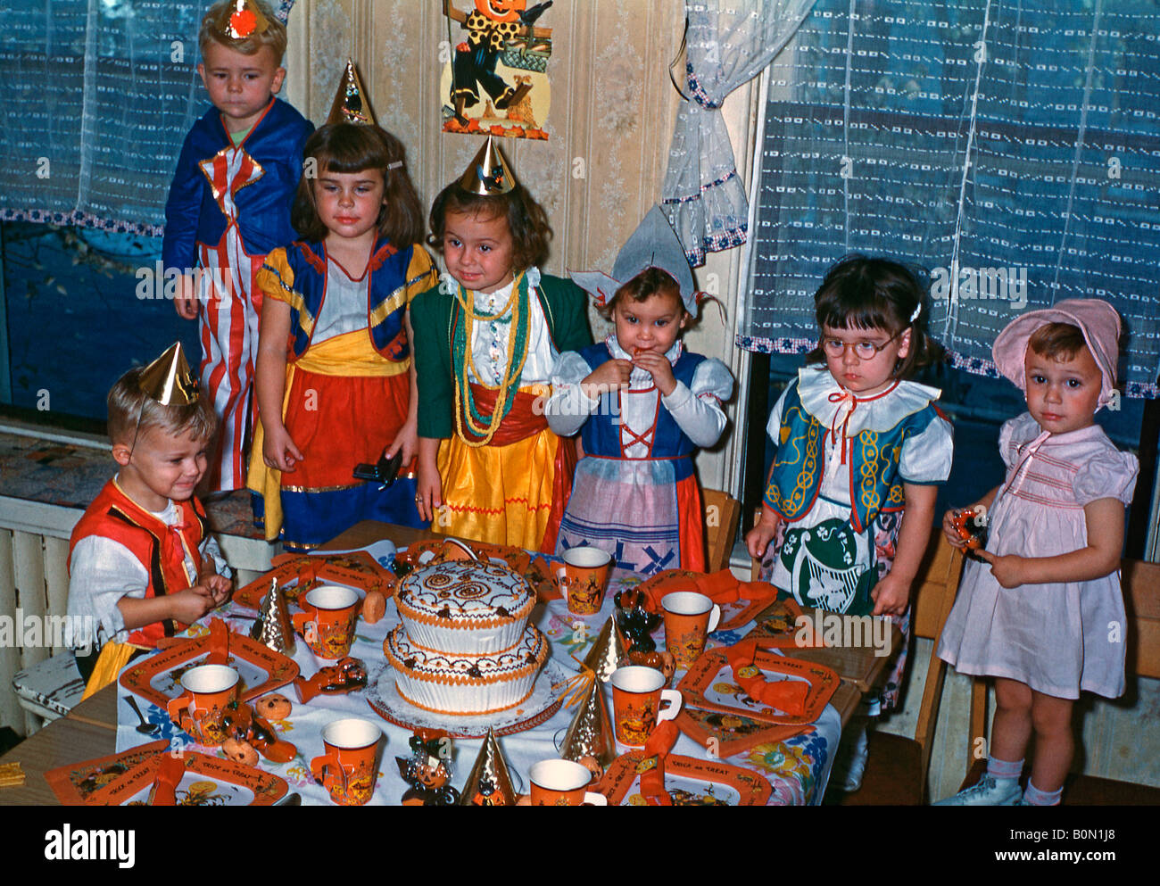 Children and a table set for a Halloween party, USA, 1950s Stock Photo