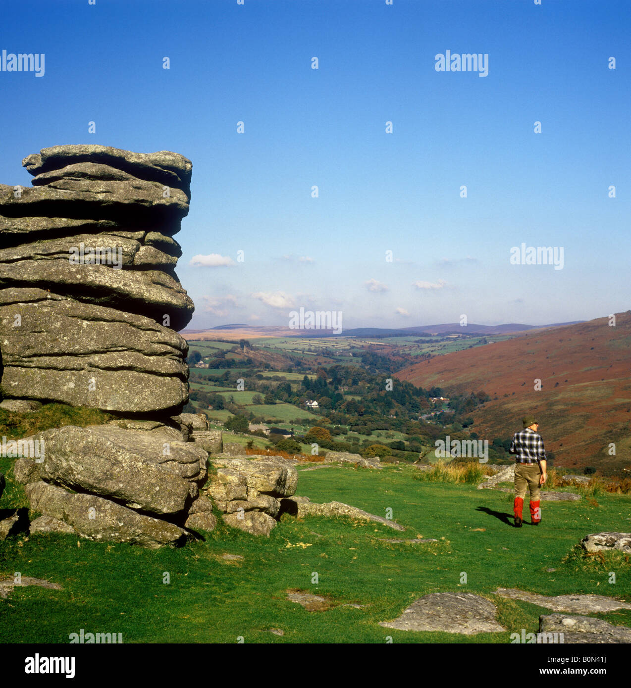 Walker on Comberstone Tor overlooking Dartmeet in the Dartmoor National ...