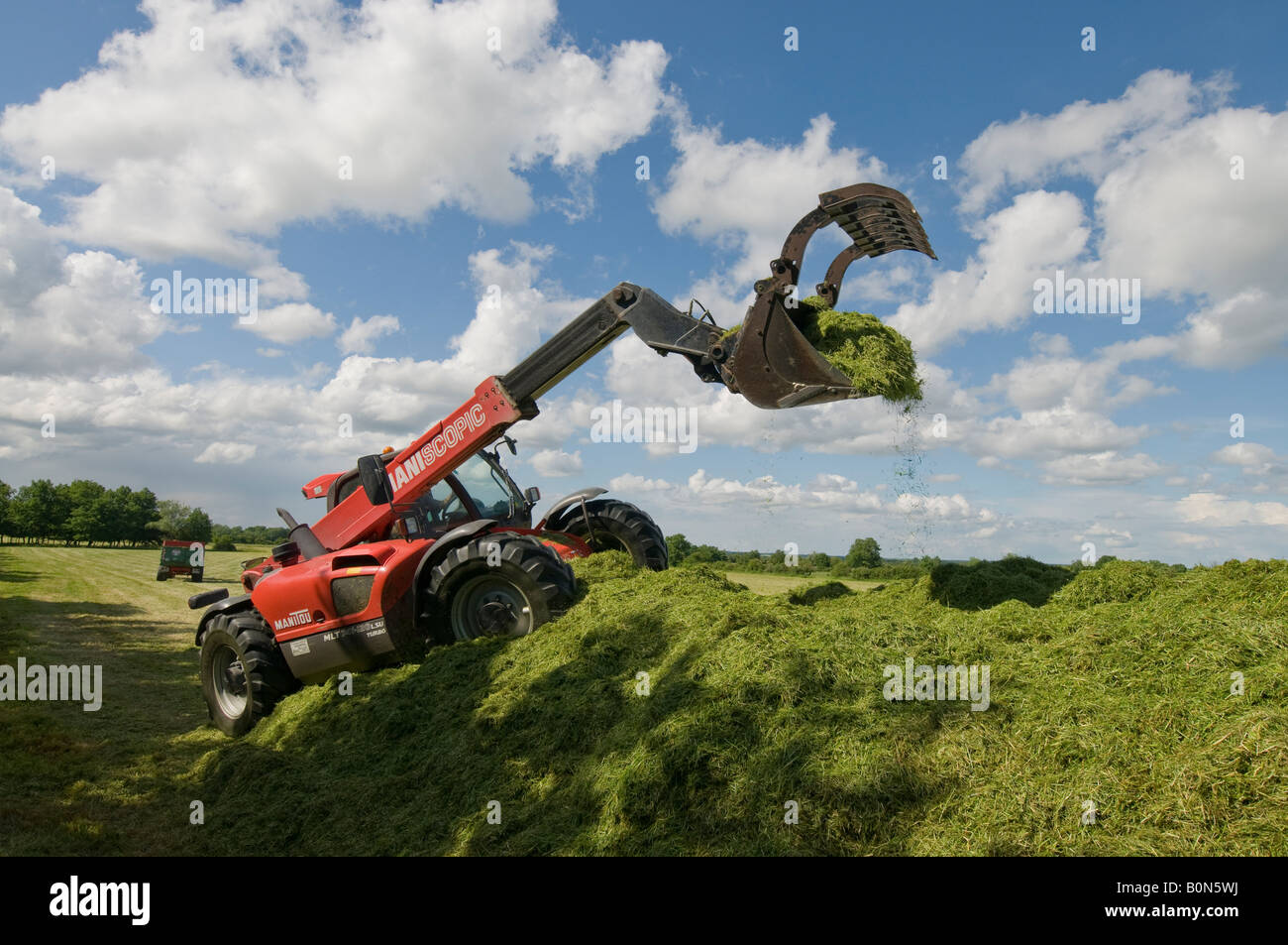 Silage collection - bulldozer / grab tractor, sud-Touraine, France. Stock Photo
