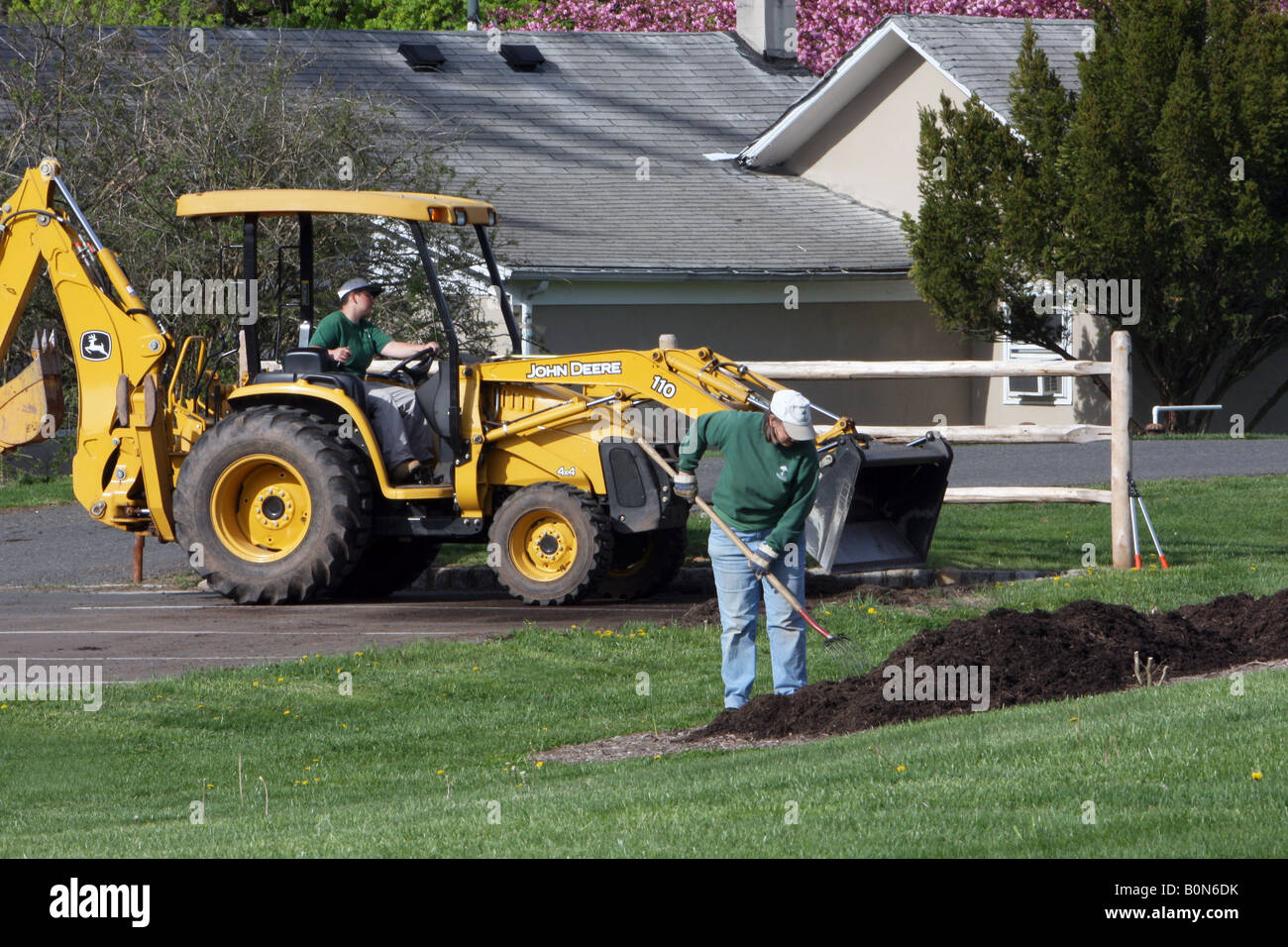 A yellow tractor with front loader and back loader Stock Photo Alamy