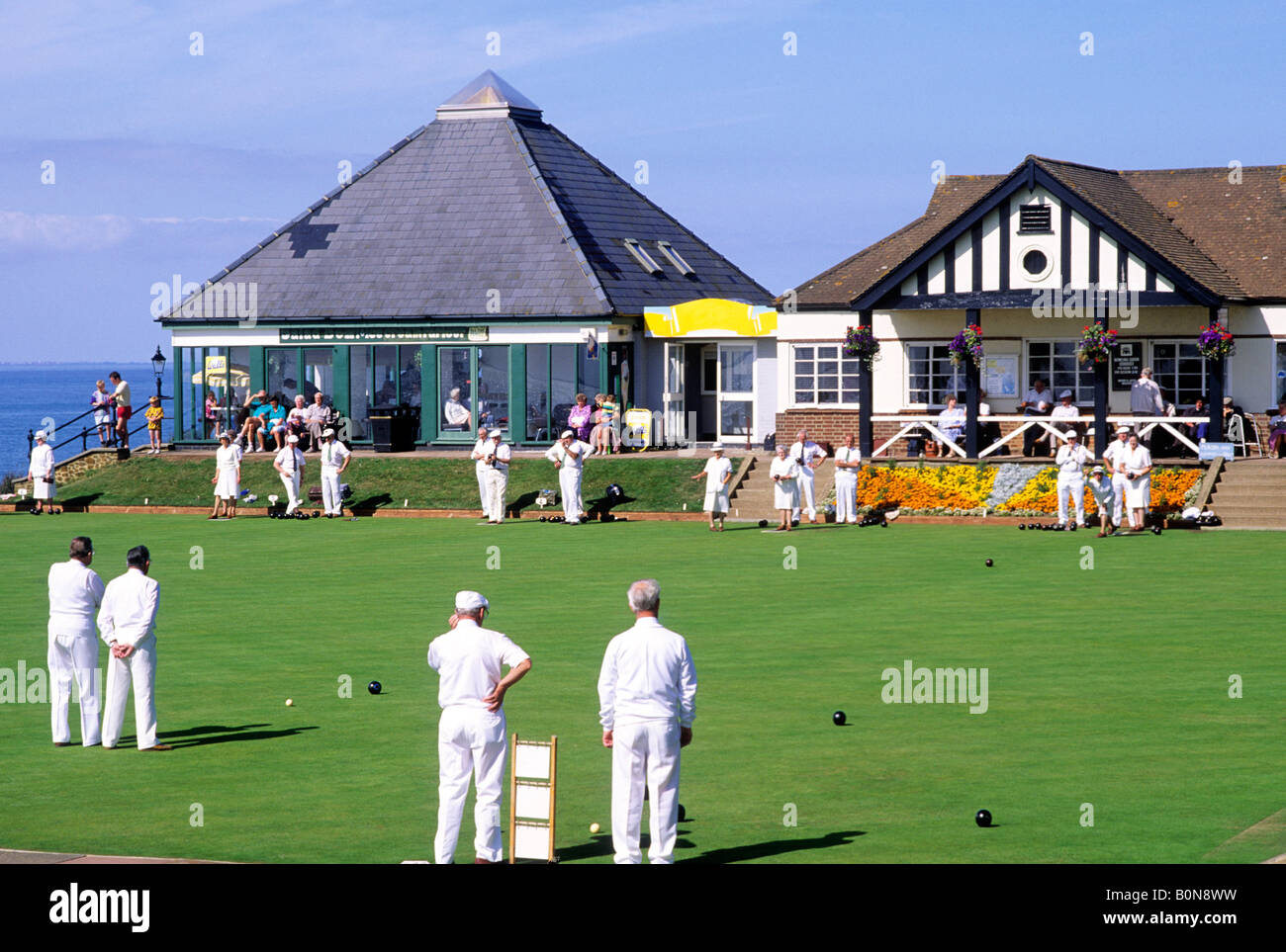 Bowls outdoor bowling green clubhouse whites Hunstanton cliff Norfolk sport game North Sea East Anglia England players playing Stock Photo