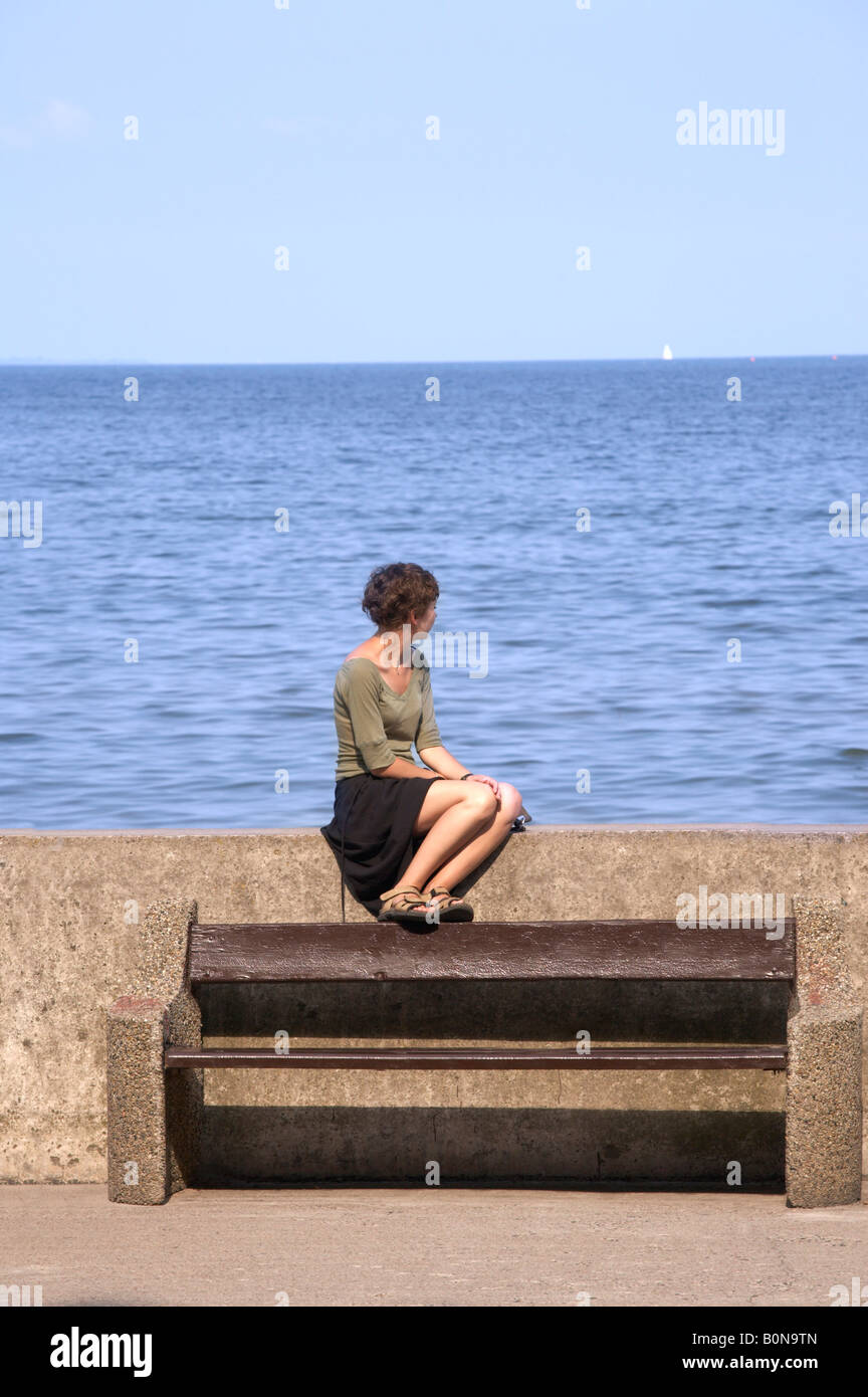 woman looking into the distance towards the horizon Stock Photo