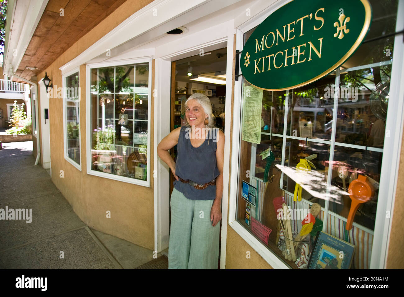 Portrait of female sales person in kitchen accessory store. Stock Photo